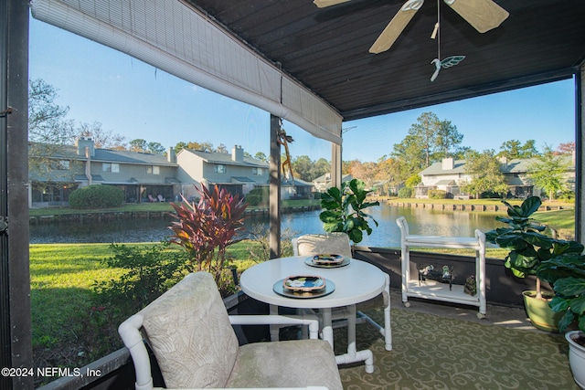 view of patio / terrace featuring ceiling fan and a water view