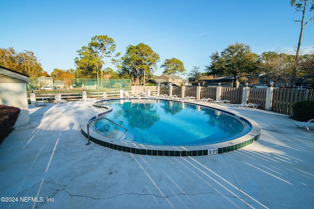 view of swimming pool featuring a patio area