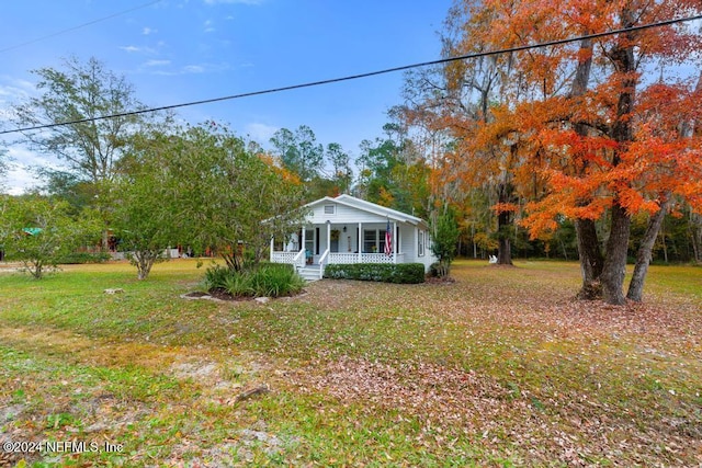 view of front of property with a front yard and a porch