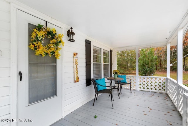 wooden terrace with a porch