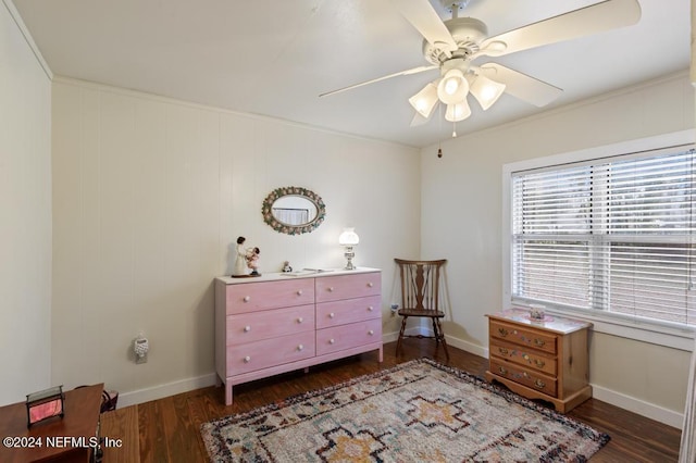 sitting room featuring crown molding, ceiling fan, and dark wood-type flooring