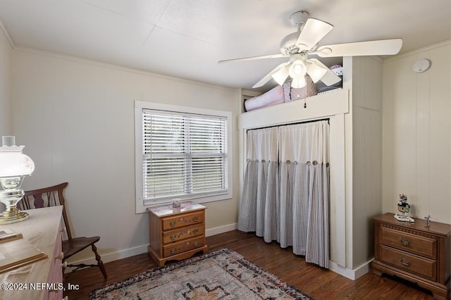 living area with dark hardwood / wood-style flooring, ceiling fan, and ornamental molding