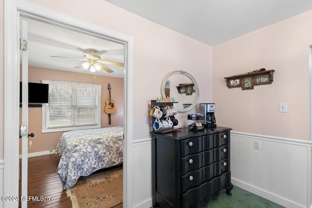 bedroom with ceiling fan and dark wood-type flooring