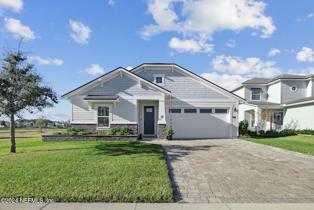 craftsman-style house with a front yard and a garage