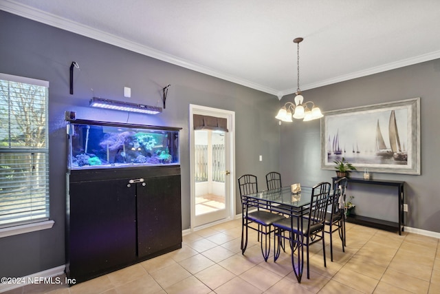 tiled dining room featuring ornamental molding and a chandelier