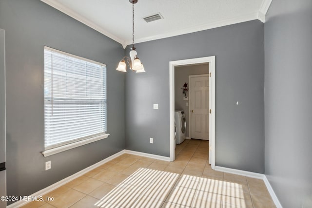 tiled empty room featuring washer and dryer, an inviting chandelier, and ornamental molding