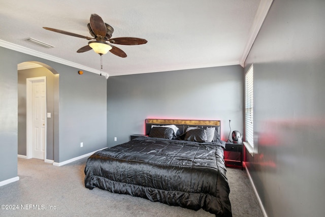 bedroom featuring carpet, a textured ceiling, ceiling fan, and ornamental molding