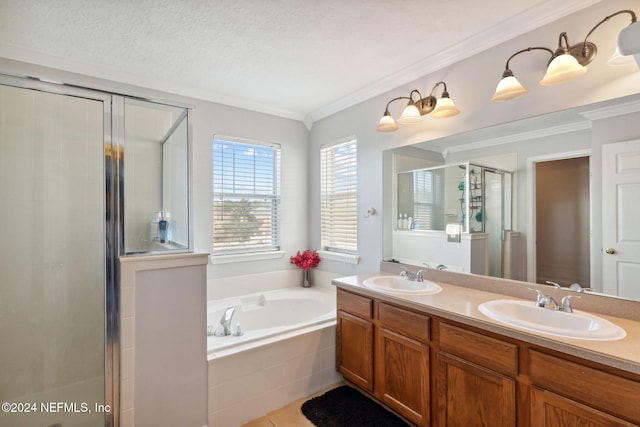 bathroom with tile patterned floors, a textured ceiling, vanity, crown molding, and independent shower and bath