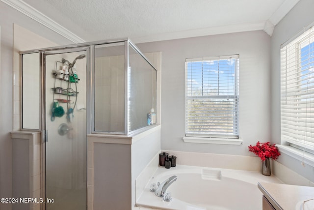 bathroom featuring shower with separate bathtub, vanity, a textured ceiling, and ornamental molding