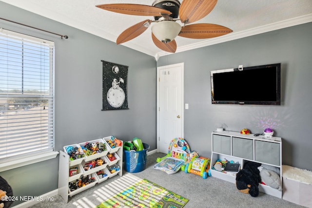 rec room featuring a textured ceiling, ceiling fan, carpet floors, and crown molding