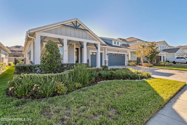 view of front facade with a garage and a front lawn