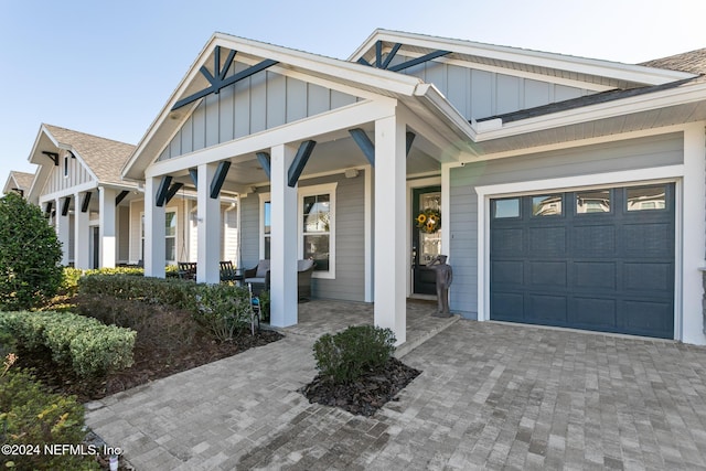 view of front of house featuring a porch and a garage