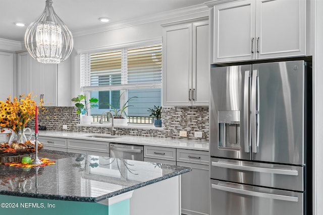 kitchen with appliances with stainless steel finishes, tasteful backsplash, dark stone counters, crown molding, and a center island