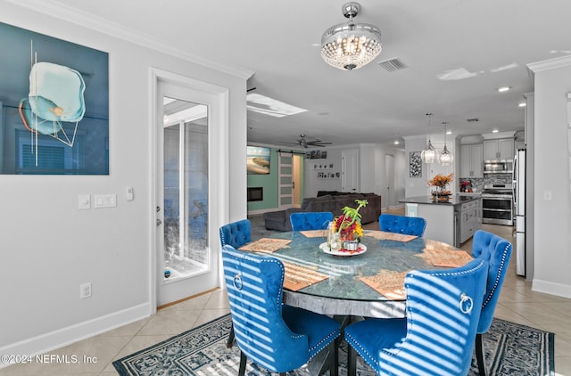 tiled dining area featuring ceiling fan and crown molding