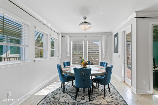 tiled dining space with ornamental molding and an inviting chandelier