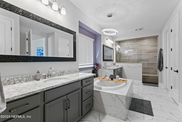 bathroom featuring vanity and independent shower and bath