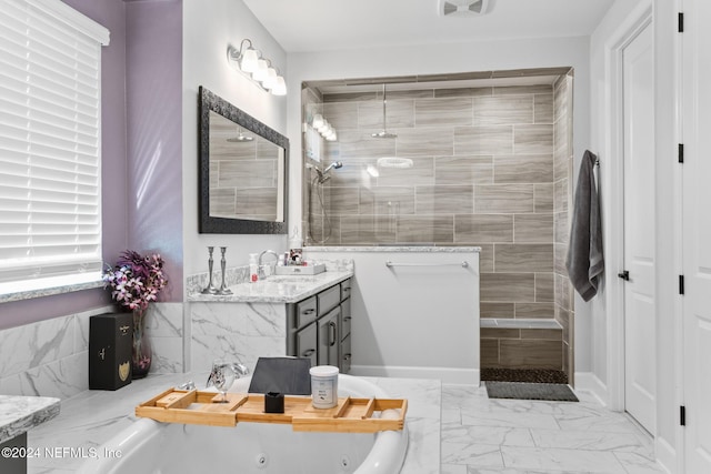 bathroom with vanity and independent shower and bath