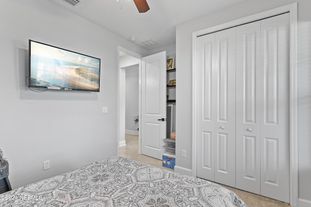 bedroom with ceiling fan and a closet