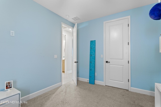 unfurnished bedroom with light colored carpet