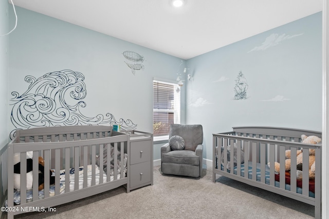 carpeted bedroom featuring a crib