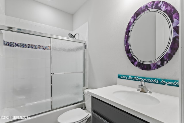 full bathroom with shower / bath combination with glass door, vanity, and toilet