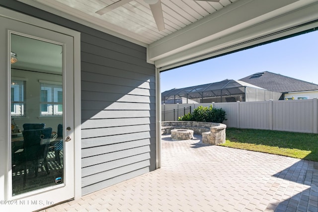 view of patio / terrace featuring ceiling fan and an outdoor fire pit