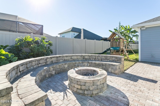 view of patio featuring a fire pit and a playground