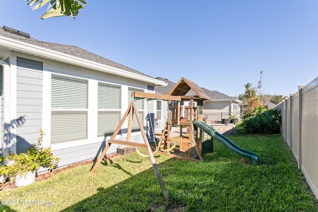 view of jungle gym with a lawn