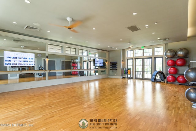 exercise room with french doors, light wood-type flooring, and ceiling fan