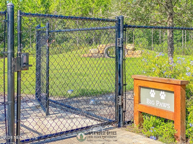 view of gate featuring a yard