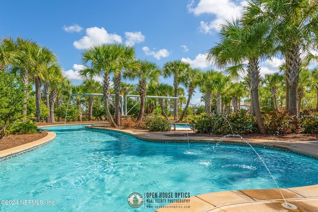 view of pool with pool water feature