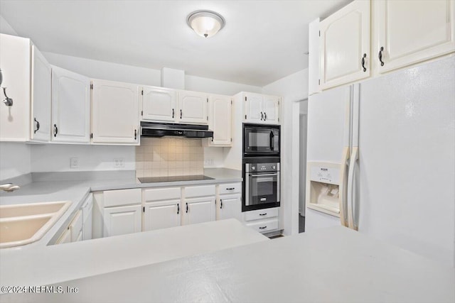 kitchen featuring decorative backsplash, white cabinetry, sink, and black appliances