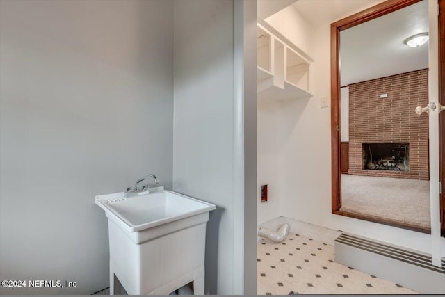 bathroom with a fireplace and sink