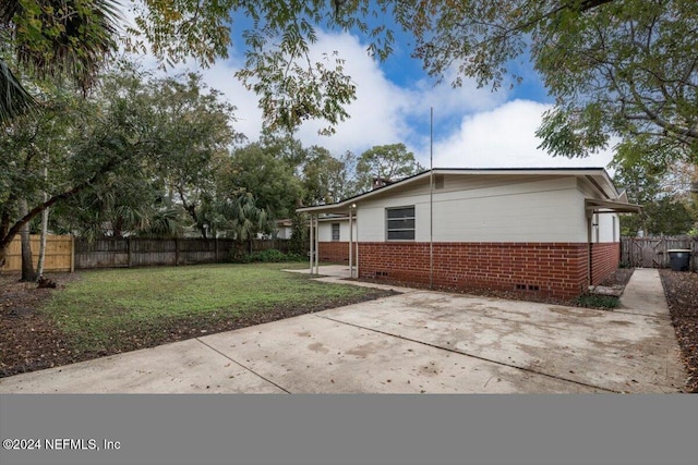 view of side of property with a yard and a patio