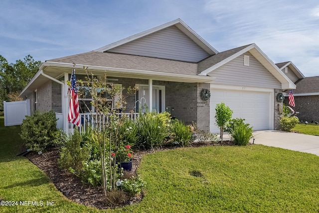 view of front facade with a porch, a garage, and a front lawn