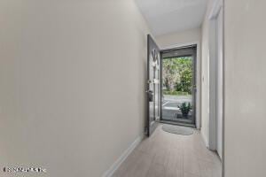 hallway with light hardwood / wood-style floors