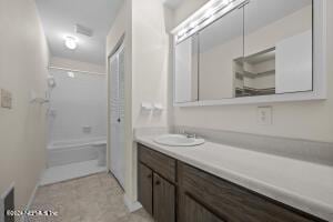 bathroom featuring shower / bathing tub combination and vanity