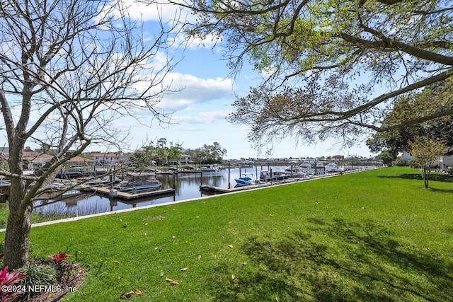 dock area featuring a yard and a water view