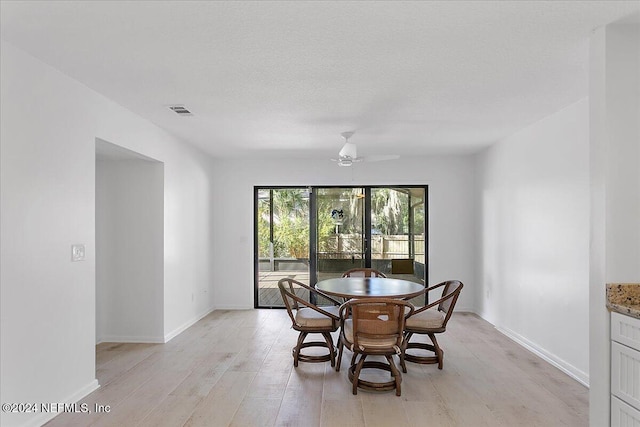 dining area featuring light hardwood / wood-style floors and ceiling fan