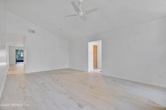 empty room with ceiling fan, light hardwood / wood-style flooring, and lofted ceiling