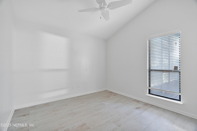 empty room with ceiling fan and lofted ceiling