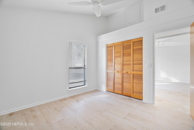 unfurnished bedroom with ceiling fan, a closet, and light hardwood / wood-style flooring