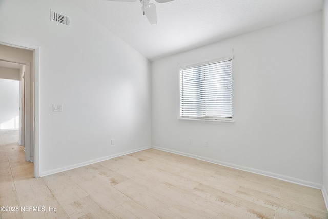 spare room with a textured ceiling, light hardwood / wood-style flooring, and ceiling fan