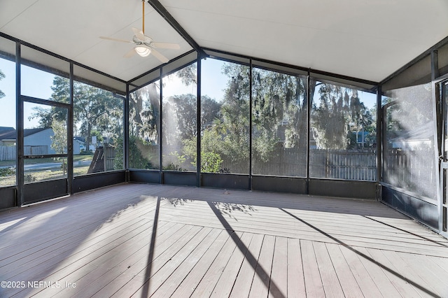 unfurnished sunroom with ceiling fan, a wealth of natural light, and vaulted ceiling