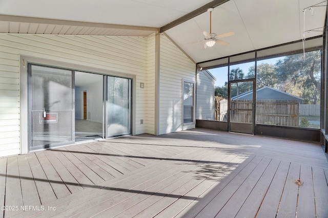 unfurnished sunroom with ceiling fan and lofted ceiling