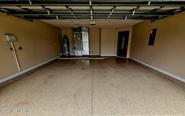 garage with heating unit, electric panel, and gas water heater