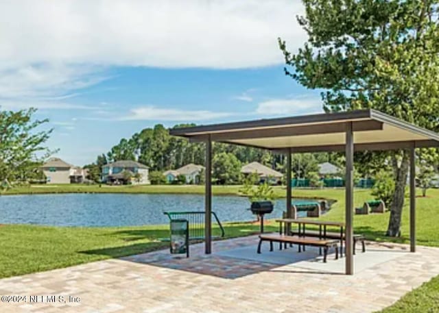 surrounding community featuring a lawn, a water view, and a gazebo