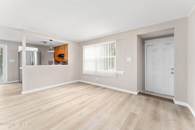 unfurnished living room with light hardwood / wood-style flooring