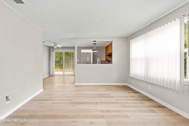 spare room featuring ceiling fan and light wood-type flooring