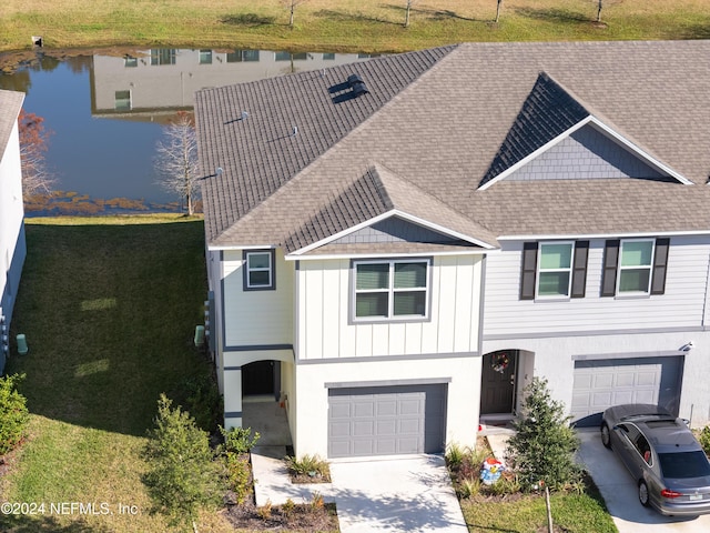 view of front of house featuring a garage and a water view